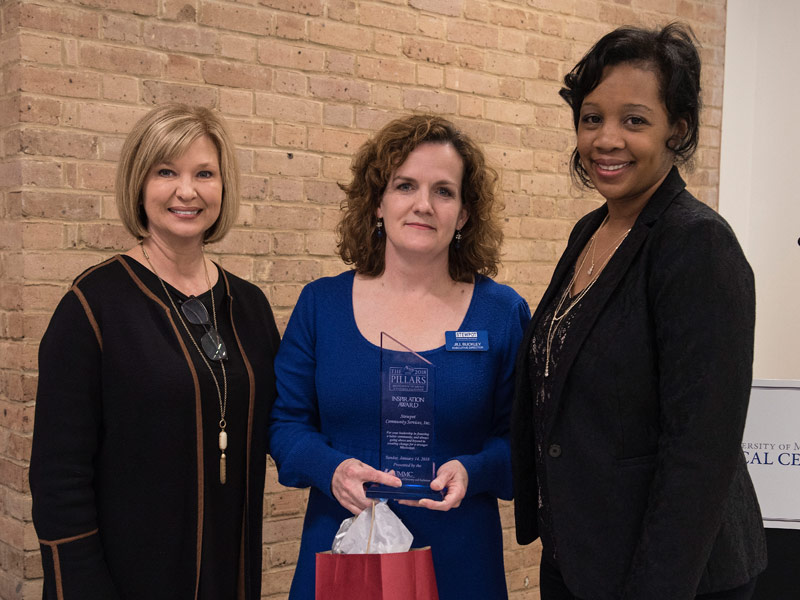 From the left are Woodward, Jill Barnes Buckley, executive director of Stewpot Community Services, and Taylor.