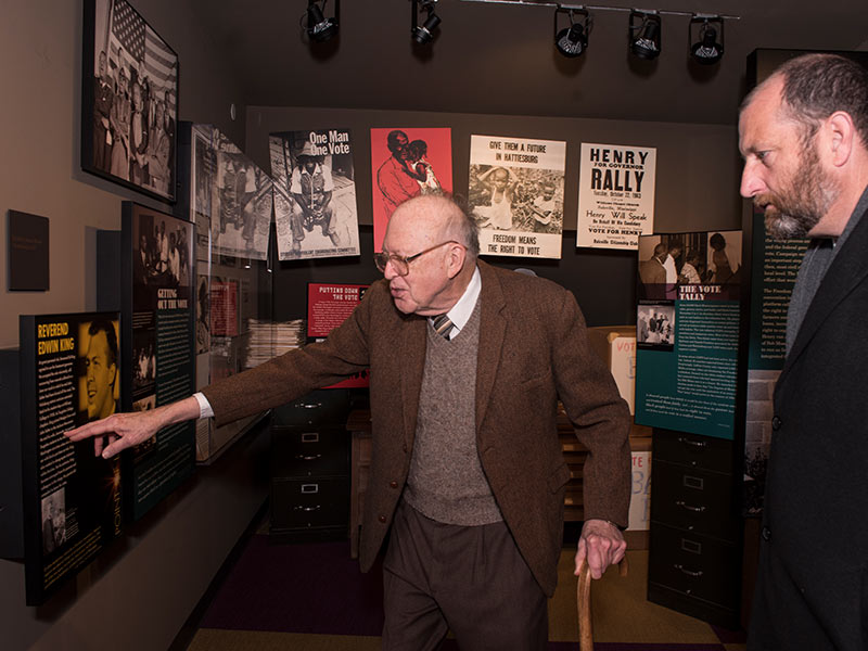 Touring the Mississippi Civil Rights Museum with Chris Goodwin, right, director of public information for the Department of Archives and History, the King points out his former wife's name in an exhibit describing his work in the movement.