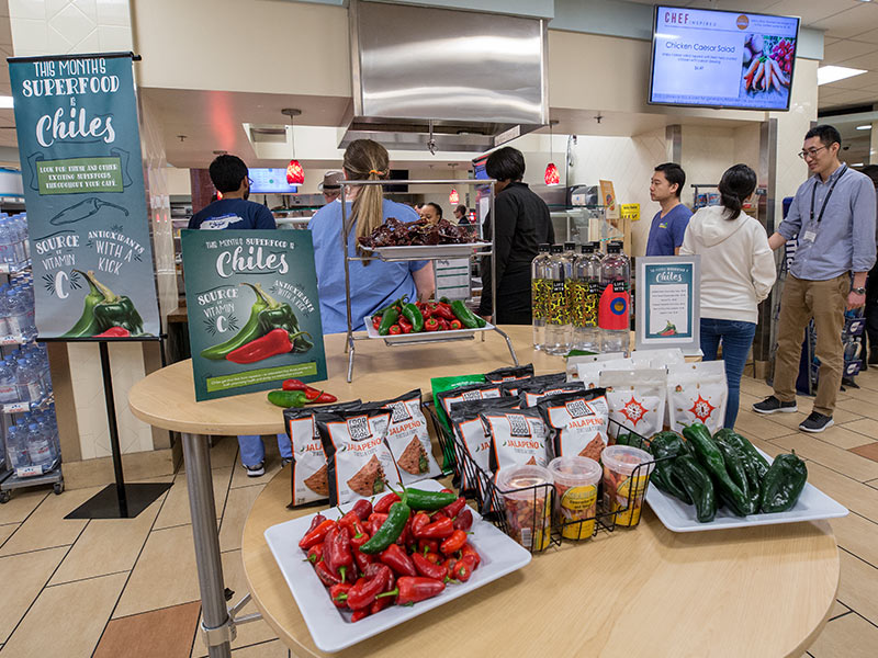 The cafeteria's "superfood" display features a themed variety of fruits and vegetables. The current offering: chili peppers rich in Vitamin C.
