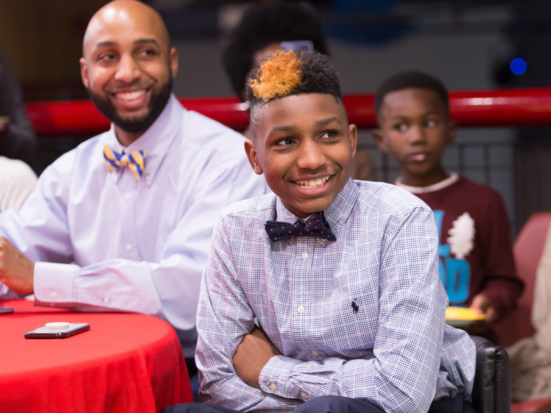 With father Kelvin Fields looking on, KJ Fields smiles as he is announced 2018 Children's Miracle Network Hospitals Champion for Mississippi.