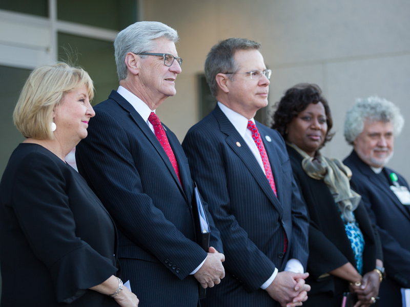 Joining Gov. Phil Bryant at ceremonies to formally name the Phil Bryant Medical Education Building were (standing, from left) his wife, Deborah; University of Mississippi Chancellor Jeffrey Vitter; Dr. Loretta Jackson-Williams, vice dean for medical education and professor of emergency medicine; and UMMC Chaplain Jeffrey Murphy.