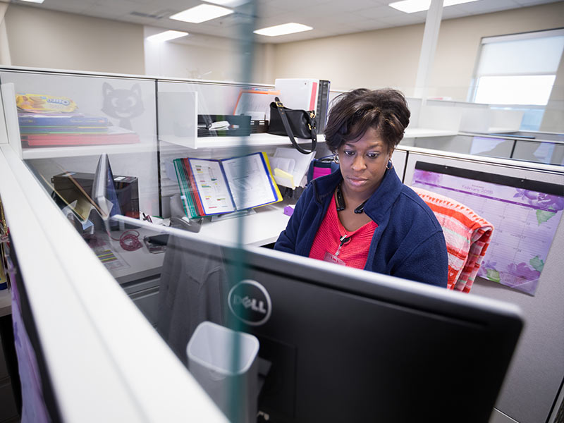 Physician scheduler Ketina Moore works at her station at the new JMMAC.