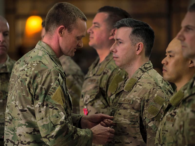 Maj. Justin Manley, third from right, receives the Bronze Star from his commander, Lt. Col. Eli Mitchell, second from left, during a Feb. 13 ceremony at the University of Alabama-Birmingham.