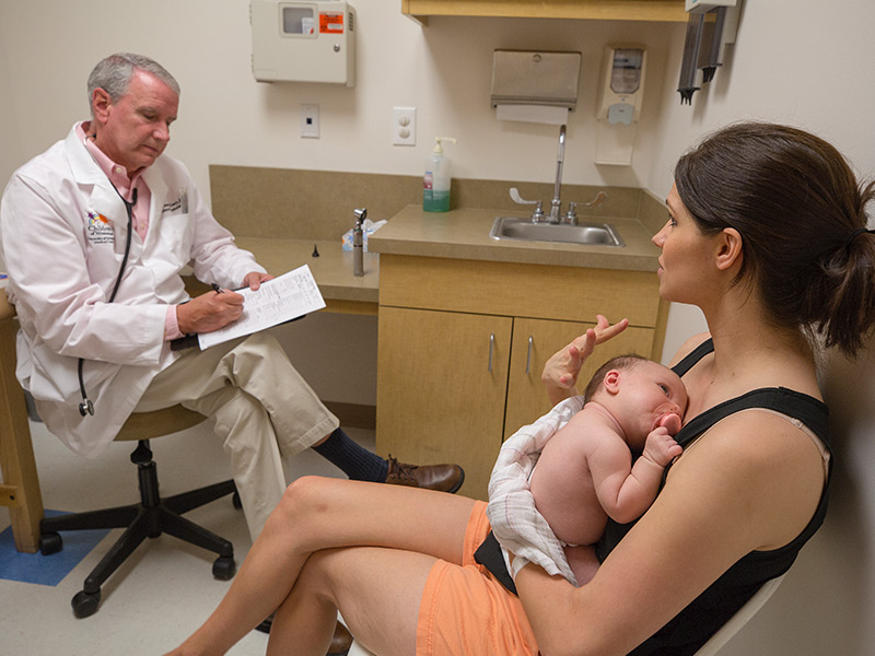 Dr. Richard McCrary talks with mom Tara Ulrich of Long Beach during baby Laykin's check-up at the Children's of Mississippi Gulfport clinic at Acadian Court.