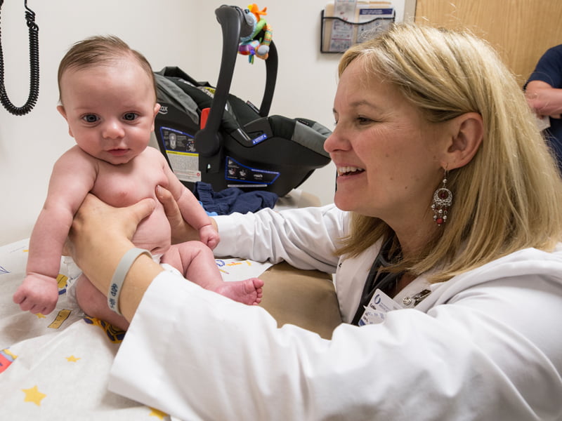 Dr. Cathie Donald takes a look at Ty Cobb of Gulfport at the new Children's of Mississippi clinic at Acadian Court.