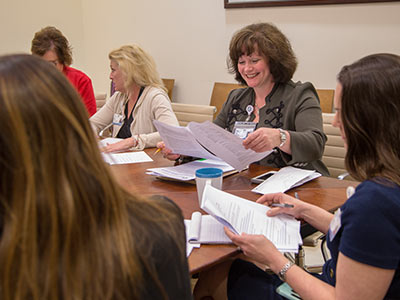 Henderson meets with her team.