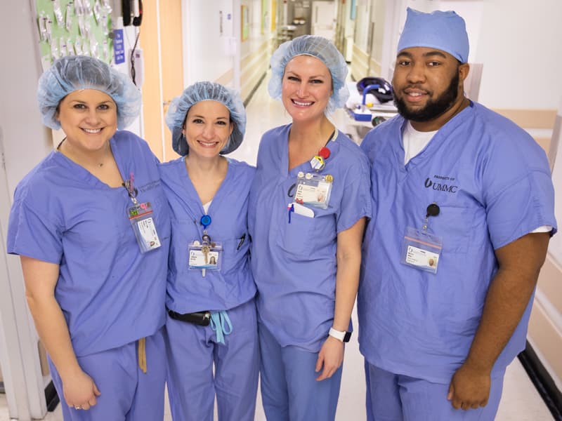 From left, nurse manager Mary Leigh Rodgers, registered nurse Jennifer Butler, registered nurse Carrie Coker and surgical support tech Maurice White sport their official UMMC scrubs in the main OR.