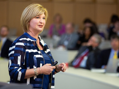 Dr. LouAnn Woodward, vice chancellor for health affairs and dean of the School of Medicine, welcomes a couple hundred visitors, along with UMMC faculty members and staff, to the SGEA event on Thursday.