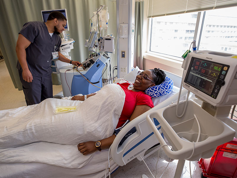 Nurse Shelby McNair, an apheresis specialist, explains part of the process to Jessica Dobbins as she donates stem cells.