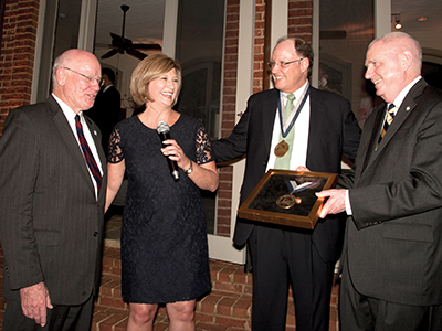 Dr. LouAnn Woodward shares a laugh with (from left) Keeton, Harmon and Dr. Dan Jones at the announcement of an endowed chair in pediatric urology named in honor of Keeton. Harmon is the chair's first recipient.