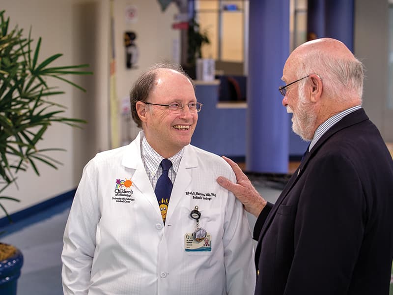 Dr. Edwin Harmon and Dr. James Keeton, friends and colleagues since the 1970s, share a conversation in the lobby of Batson Children’s Hospital.