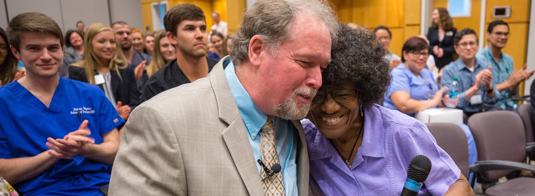 Ramsey hugs Annie Cooper, patient