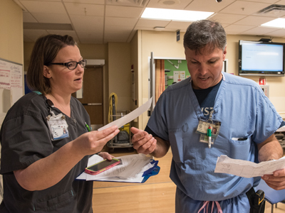 Kesha Prystupa, a Pediatric ED nurse manager, and Blake Jones, a registered nurse and educator, discuss "patients on paper" expected in their area as part of a mass casualty exercise.