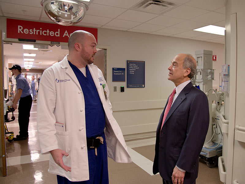 During his 2015 visit to the Medical Center, Dr. Mark Chassin, right, president and CEO of the Joint Commission, received a tour of the adult ED from its clinical director, Jason Zimmerman.
