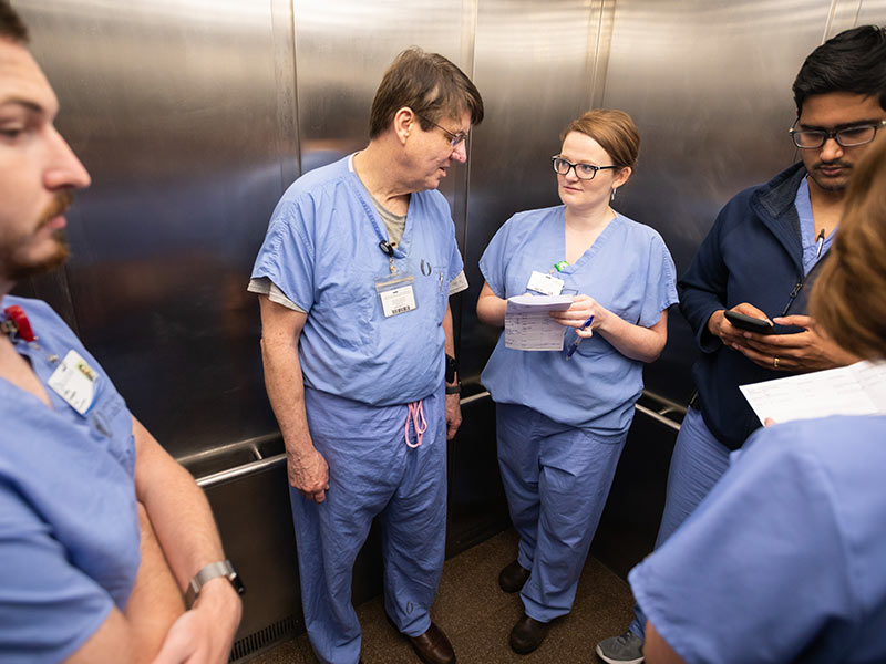 Dr. Meagan Mahoney, center right, general surgery resident, grabs an elevator conversation with Dr. Larry Martin, UMMC professor of surgery and trauma surgeon.