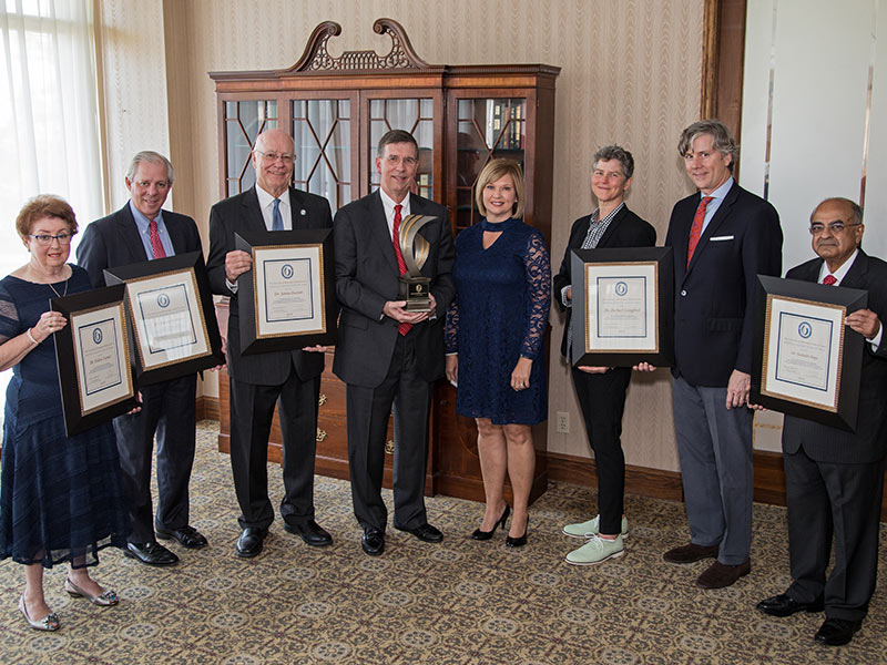 Flanking Dr. LouAnn Woodward, fifth from left, vice chancellor for health affairs and dean of the School of Medicine, are, from left, Dr. Helen Turner, Dr. Robert Robbins and Dr. James Keeton, Hall of Fame honorees; Dr. Marty Tucker, distinguished medical alumnus honoree; Ellen Langford and Robert Langford, children of the late Dr. Herbert Langford, a Hall of Fame inductee; and Dr. Seshadri Raju, another Hall of Fame selectee.
