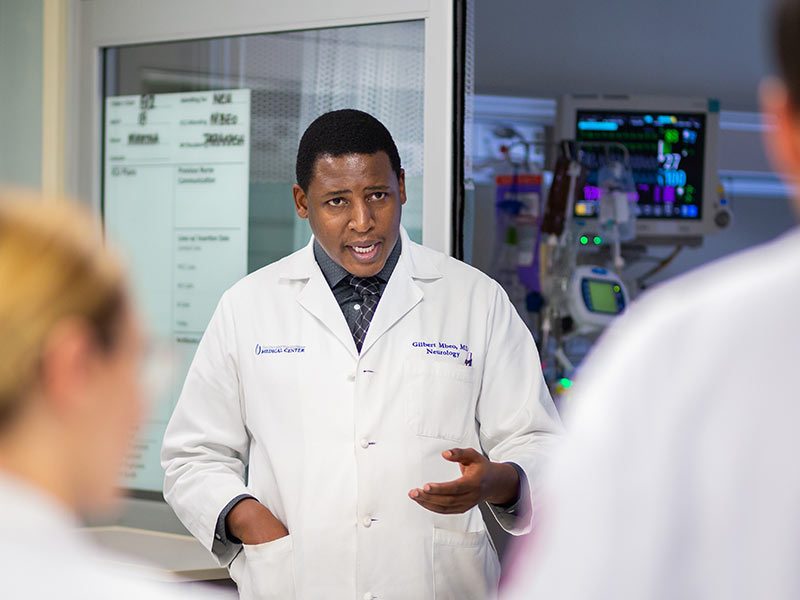 Dr. Gilbert Mbeo, assistant professor of neurology, teaches UMMC residents and medical students as part of rounding with them in the neuroscience ICU.