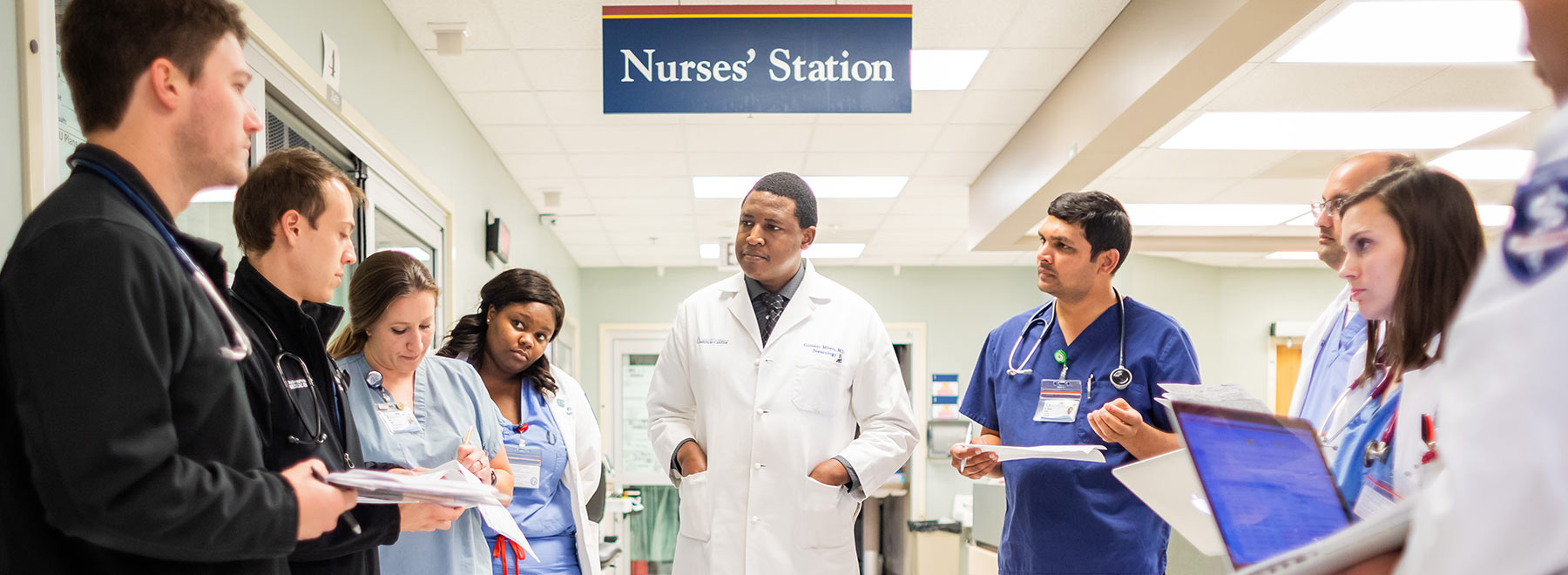 Dr. Gilbert Mbeo, assistant professor of neurology, makes rounds in the neuroscience ICU with UMMC residents and medical students.