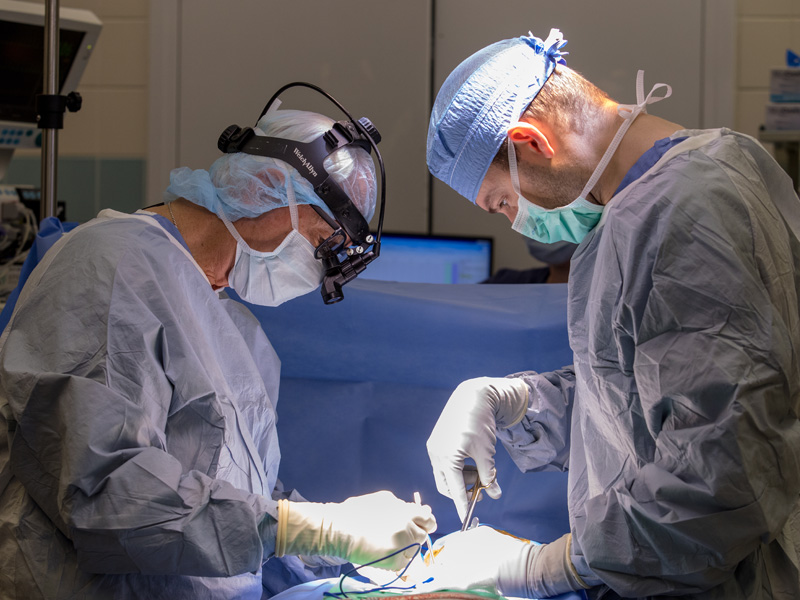 Dr. Robert McGuire, left, and surgery resident Dr. Fuller McCabe perform a spinal procedure.