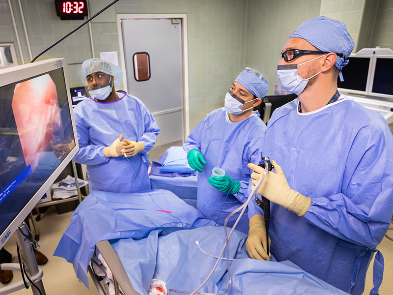 Dr. Michal Senitko, right, performs a medical thoracoscopy on patient Wayne Simpson in coordination with Dr. James T. Williams, left, and Dr. Trey Abraham,