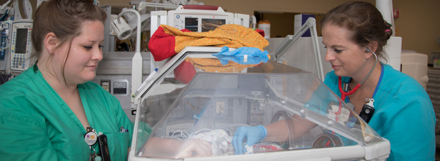 Registered nurse Anna Jacobs, left, and respiratory therapist Christy Smith monitor a patient in the UMMC neonatal intensive care unit. UMMC is part of SouthSeq, an NIH-funded study that uses whole genome sequencing to identify genetic traits that may influence the health of NICU patients.