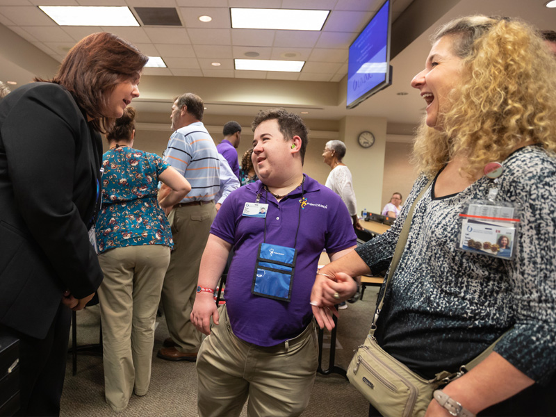Rankin County school district transition instructor Jennifer Jackson, left, welcomes Wesley Tyson, son of UMMC nursing supervisor Lori Tyson, right, to the Project SEARCH program at the Medical Center.