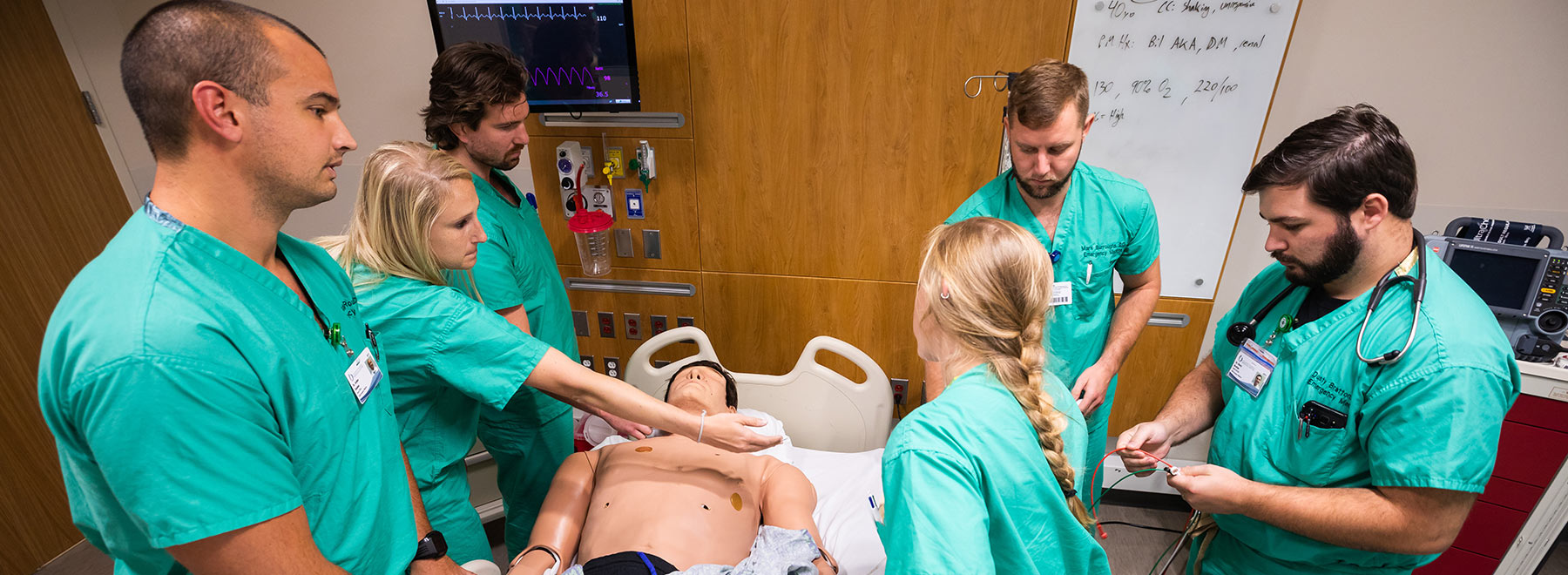 Emergency Medicine residents monitor the vital signs of their 