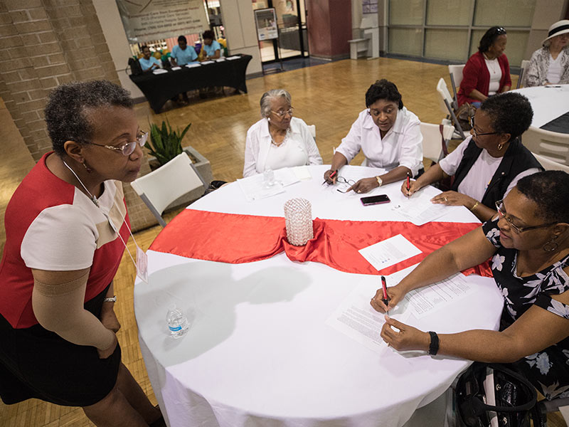 Dr. Karen Winters, left, UMMC professor of nursing and associate director of the JHS Field Site, answers a question from Sheila Gibson of Jackson during the Community Mix and Mingle.