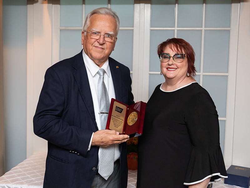 Letitia Thompson, right, vice president of cancer control for the American Cancer Society's South Region, presents Dr. John Ruckdeschel, UMMC Cancer Institute director, with the society's St. George Award during a reception Thursday in Jackson.