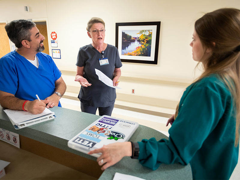 Randy Khalaf, left, occupational therapist, Marina Baldwin, center, 3 North nurse manager, and Brandi Alexander, physical therapist, discuss care for post-surgery patients.