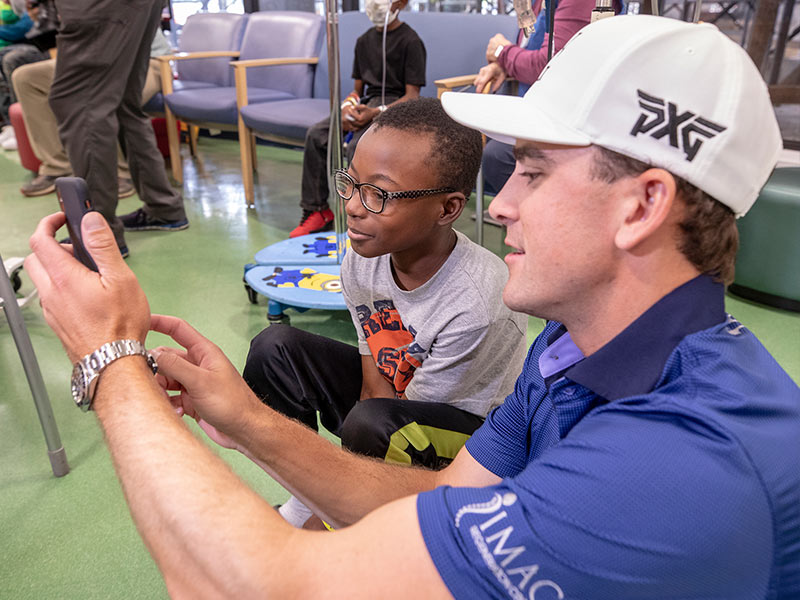 Sanderson Farms Championship golfer Scott Langley takes a selfie with Batson Children's Hospital patient Keydarius Taylor of Meridian.