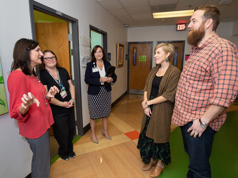 From left, Anita Vanderford, Ashley Prendez and Dr. Mary Taylor give Erin and Ben Napier, hosts of HGTV's "Hometown," a tour of the Children's Cancer Center.