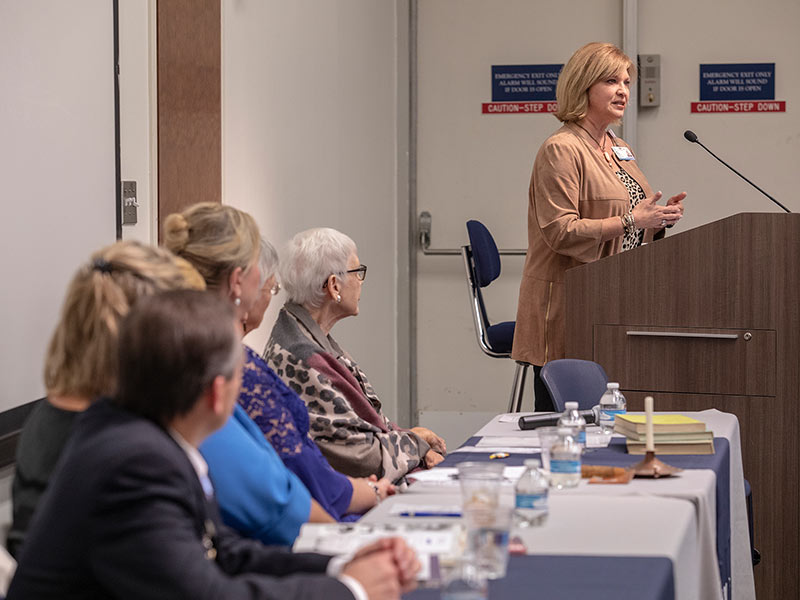 School of Nursing graduates listens as LouAnn Woodward, vice chancellor for health affairs and dean of the School of Medicine, addresses the crowd at the School of Nursing's 70th anniversary event.