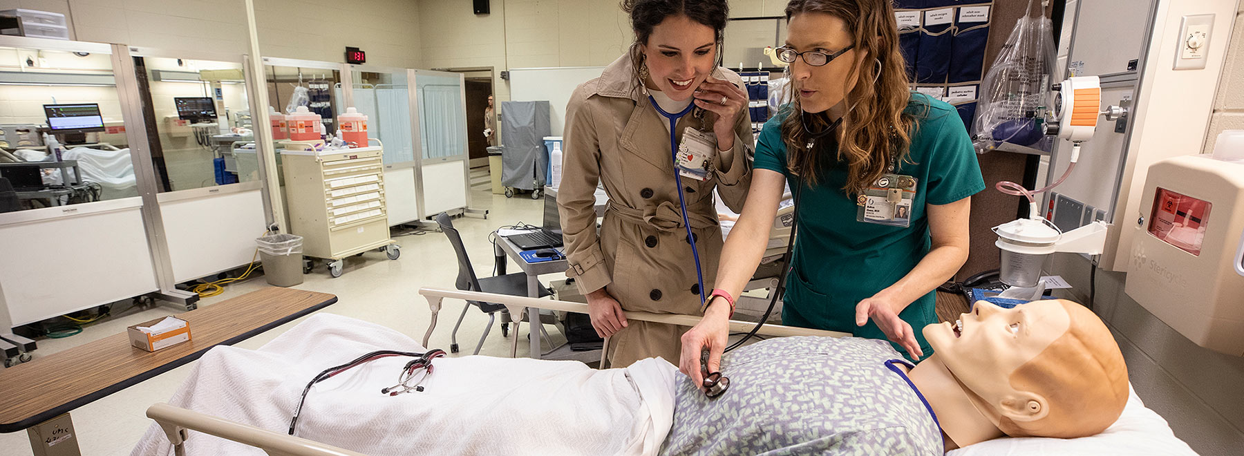 School of Nursing alumna Presly Lowry, left, RN, CICU, checks out the new and improved high fidelity simulator with instructor Melissa Klamm.