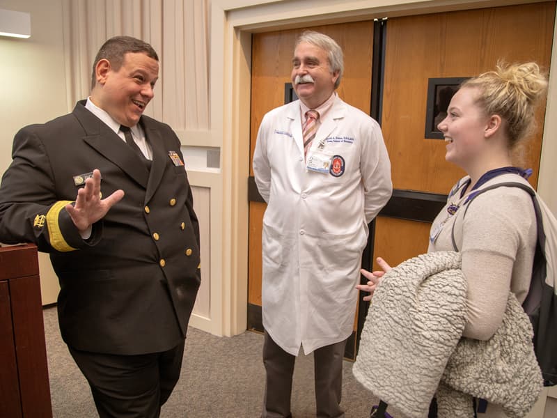 Dr. Timothy Ricks, chief dental officer for the U.S. Public Health Service, answers questions from Kaylan Inmon, dental hygiene student. as Dr. David Felton, dean of the School of Dentistry, listens.