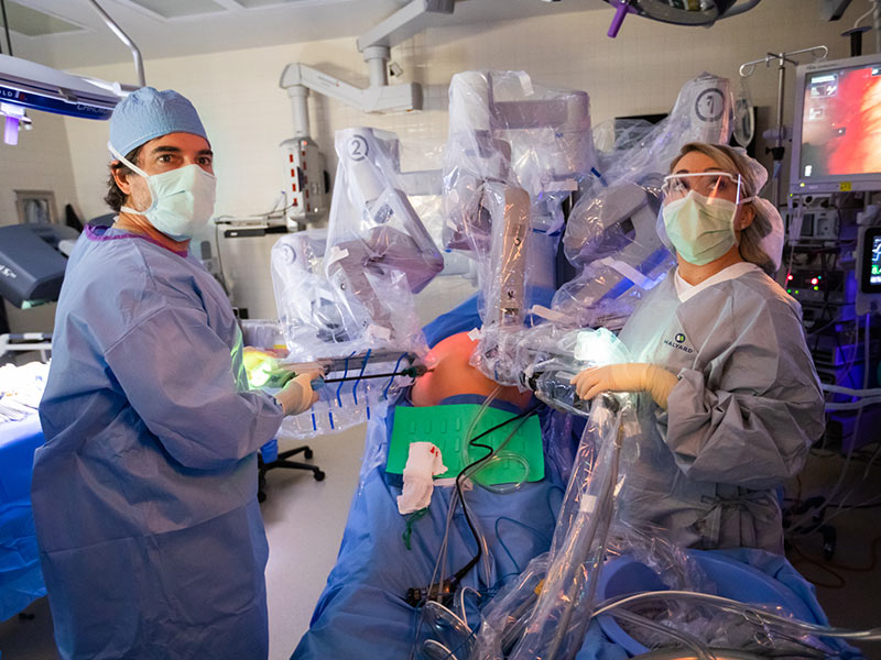 Dr. Mark Earl and chief resident Dr. Taylor Shaw work together on a robotic procedure to remove a patient's pancreatic cancer.