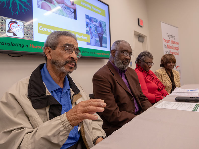 Four Jackson Heart Study participants sit at a table during a panel discussion