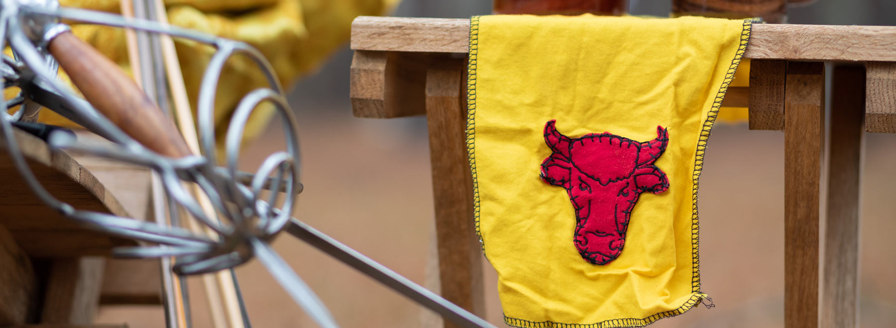 Yellow cloth with red bull on it and handle of fencing sword.