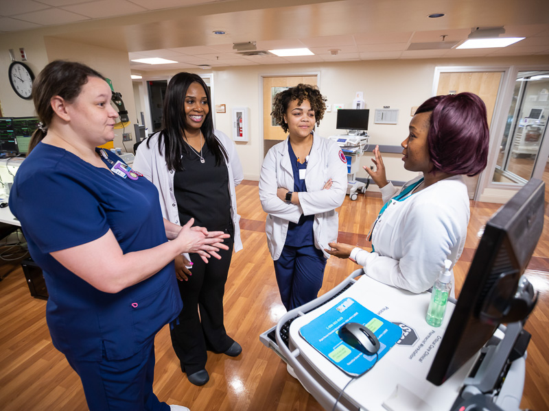 From left, Jennifer Morris, accelerated nursing student, LaVeChelle Pillers, VA nurse, Sarah Jamison, accelerated nursing student, and Joyce Sellers, VA nurse, chat about working together in the VA's intensive care unit.
