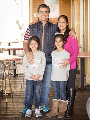 Manisha with husband Vikram Malhotra and their 8-year-old twin daughters Priya (left) and Asha Malhotra