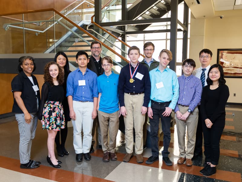 From left to right, front row, Northwest Rankin Middle School science teacher Mautoyia Cooper, You Be the Chemist participants Apple Guillory, Andy Tran, Andy Smith, Joshua Bowman, Cole Butler, Carson May and Annie Nam.   Back row, from left to right, Dr. Yuanyuan Duan, Dr. Jason Griggs, Jacob Cobb and Dr. Yongfeng Zhao.