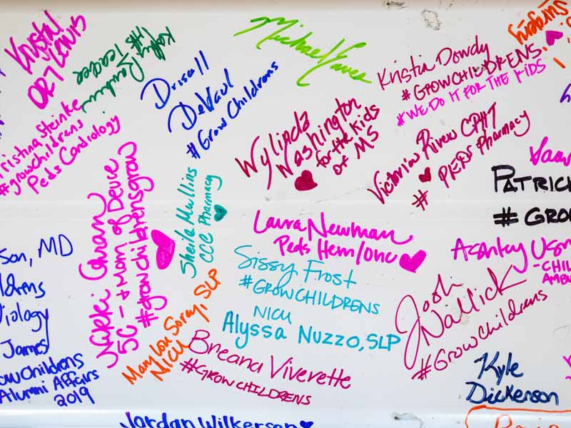 Signatures in a rainbow of Sharpie colors cover the beam that will be placed at the top of the children's expansion during a 4:30 p.m. ceremony June 27.
