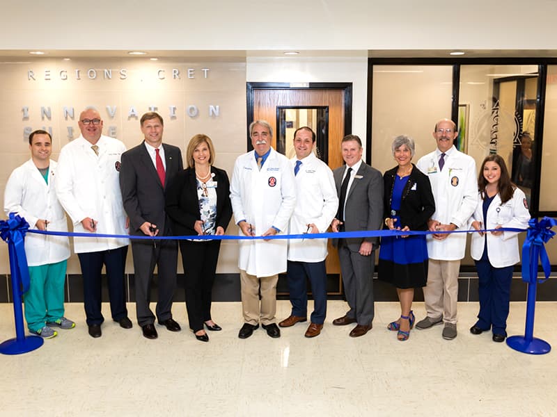 Left to right dental student Stephen Greer, Dr. Scott Phillips, John Boydstun of Regions, Dr. LouAnn Woodward, Dr. David Felton, Dr. Andres Pappa, Don Hobbs of CRET, Dr. Barbara Mauldin, Dr. Scott Gatewood, and dental hygiene student Brett Quon at the ribbon cutting ceremony for the Regions CRET Innovation Suite.