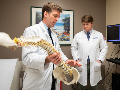Dr. Stanton Ward, left, explains details of a surgery to orthopaedic surgery resident Dr. Turner Brown.