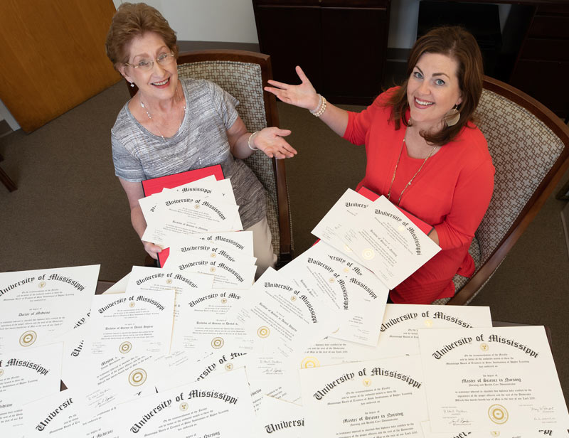 For UMMC’s former registrar Barbara Westerfield, left, and current registrar Emily Cole, it seems there’s no end to the diplomas being readied for handout during Commencement season at UMMC – and that’s a good thing!
