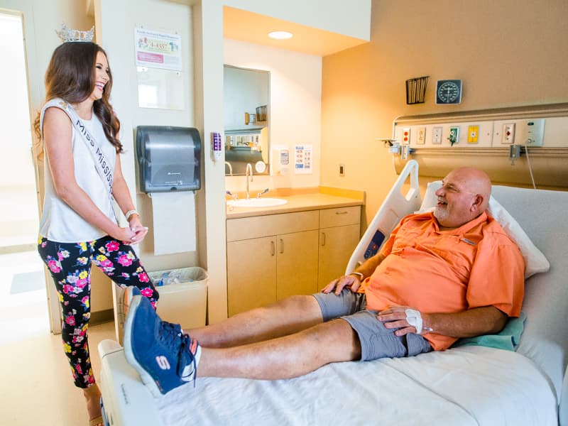 Miss Mississippi Mary Margaret Hyer shares her love of Ole Miss sports with Dan Dyess. The Columbia resident is on a waiting list for a liver transplant.