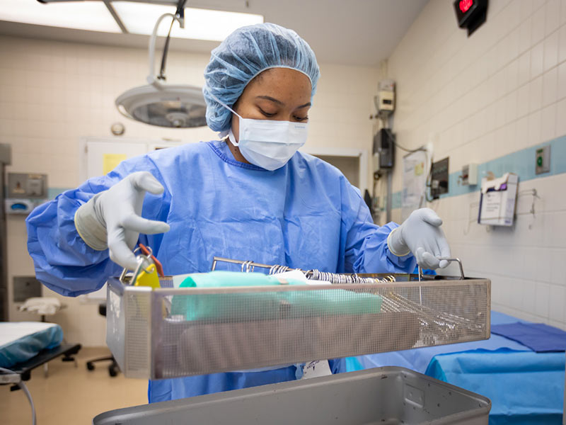 Lacey Burton, surgical technician, checks sterilized instruments as part of protocols for avoiding surgical site infections.