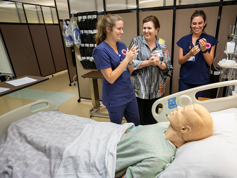 Julie Sanford, center, dean of the School of Nursing, foams her hands with nursing students Sarah Tillery, left, and Mollie Woods during a clinical exercise.