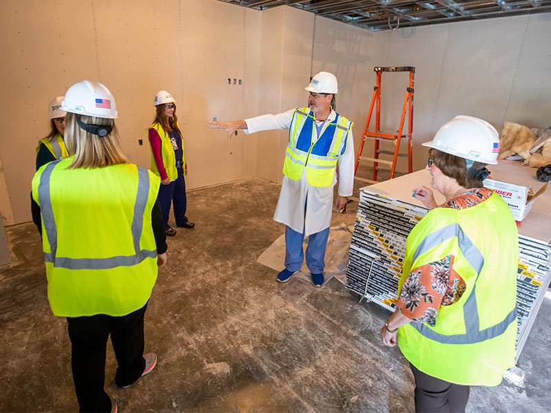 Dr. Christopher Blewett, Children's of Mississippi surgeon-in-chief, discusses features of the new surgical suites with, clockwise from center, Linda Atwood, perioperative services director; Brittani Davis, post-anesthesia care unit shift supervisor; Hailey Moore, surgical suite nurse manager; and Valerie Needham, ambulatory surgery nurse manager.