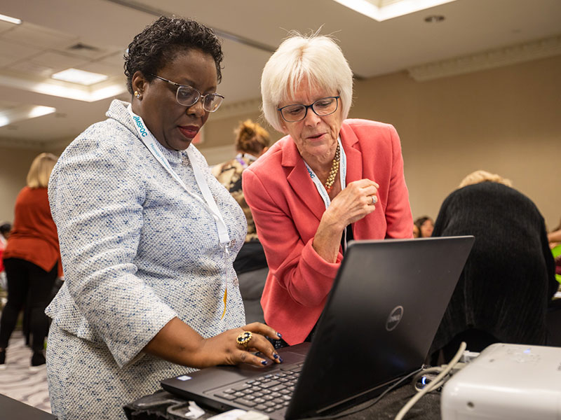 Dr. Mobolaji Famuyide, left, and Dr. Paula Meier of Rush University confer prior to an Express Yourself training session with the Mississippi Perinatal Quality Collaborative.